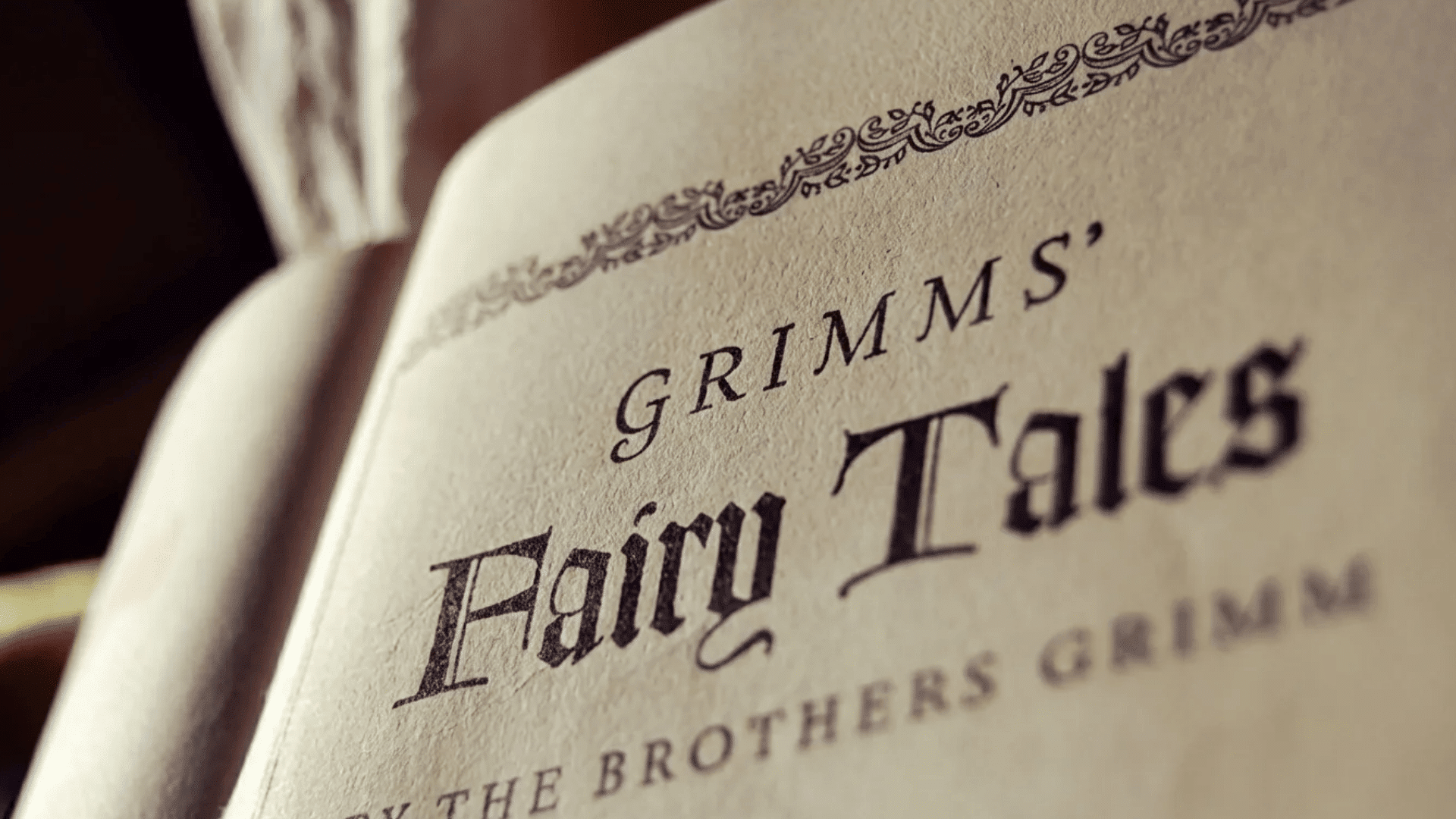 Close-up of an open book showing the title “Grimms’ Fairy Tales,” representing classic folklore and traditional storytelling