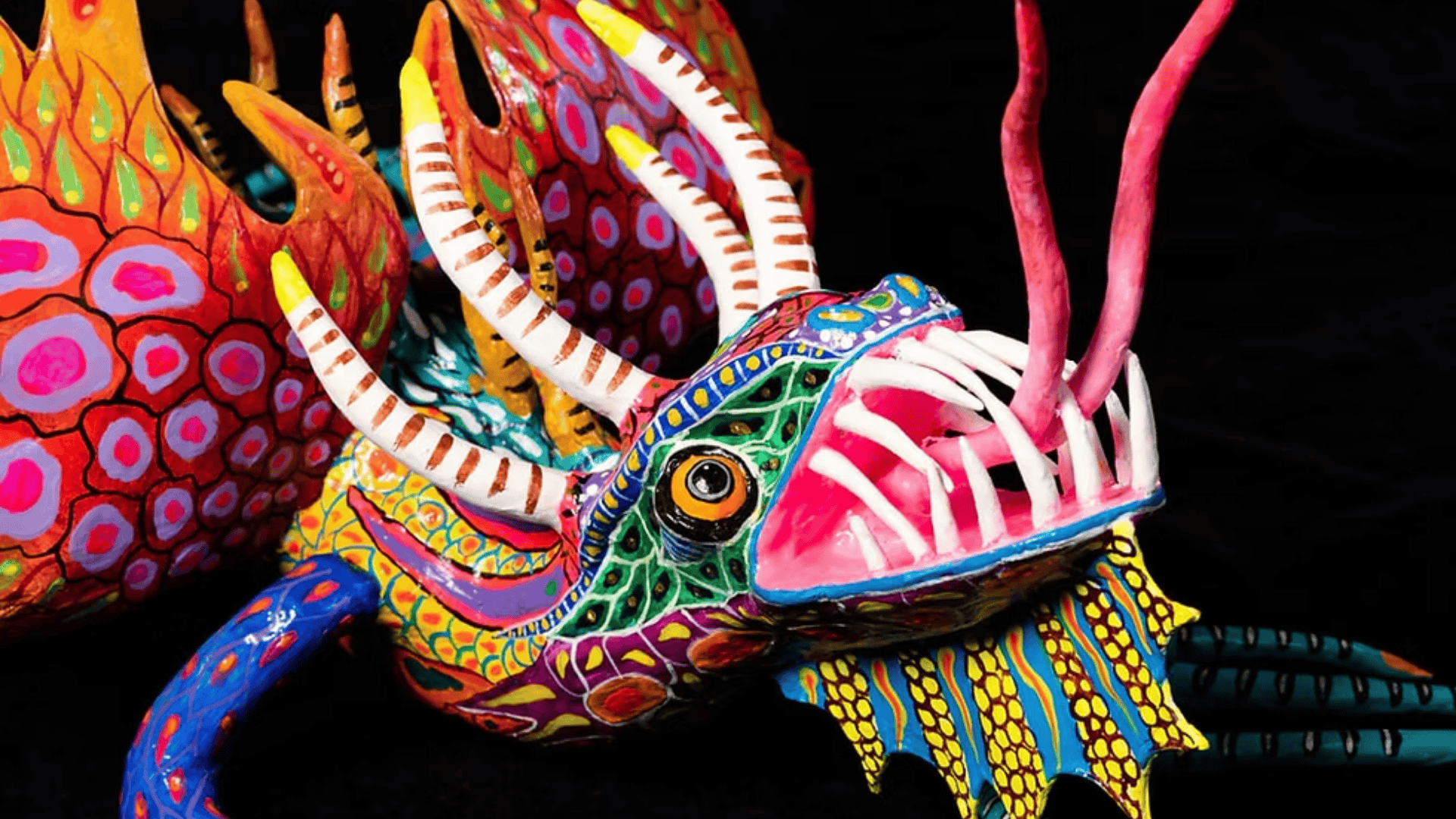 Colorful Mexican alebrije sculpture shaped like a fantastical dragon with intricate patterns and bright hand-painted details