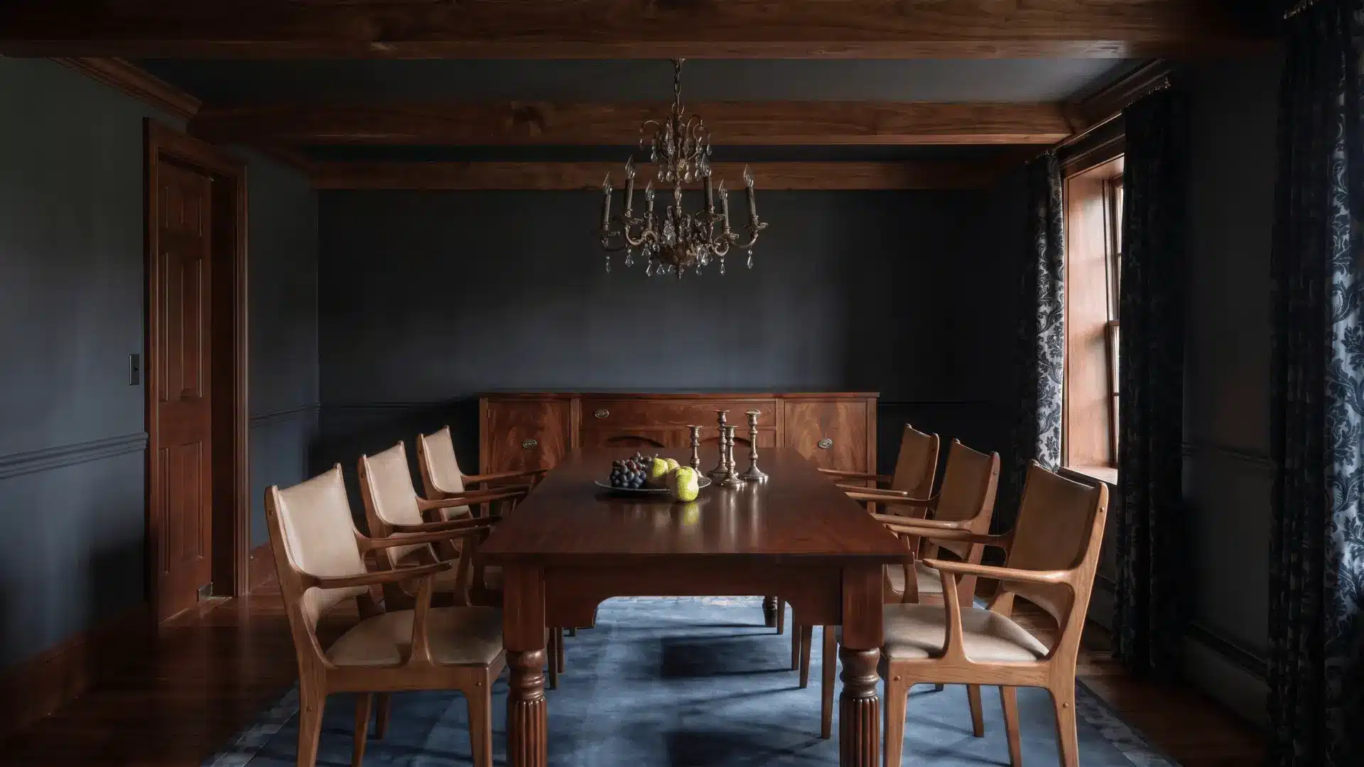 Dark academia dining room with wood table, matching chairs, chandelier lighting, dark walls, and classic curtains creating a warm, vintage feel