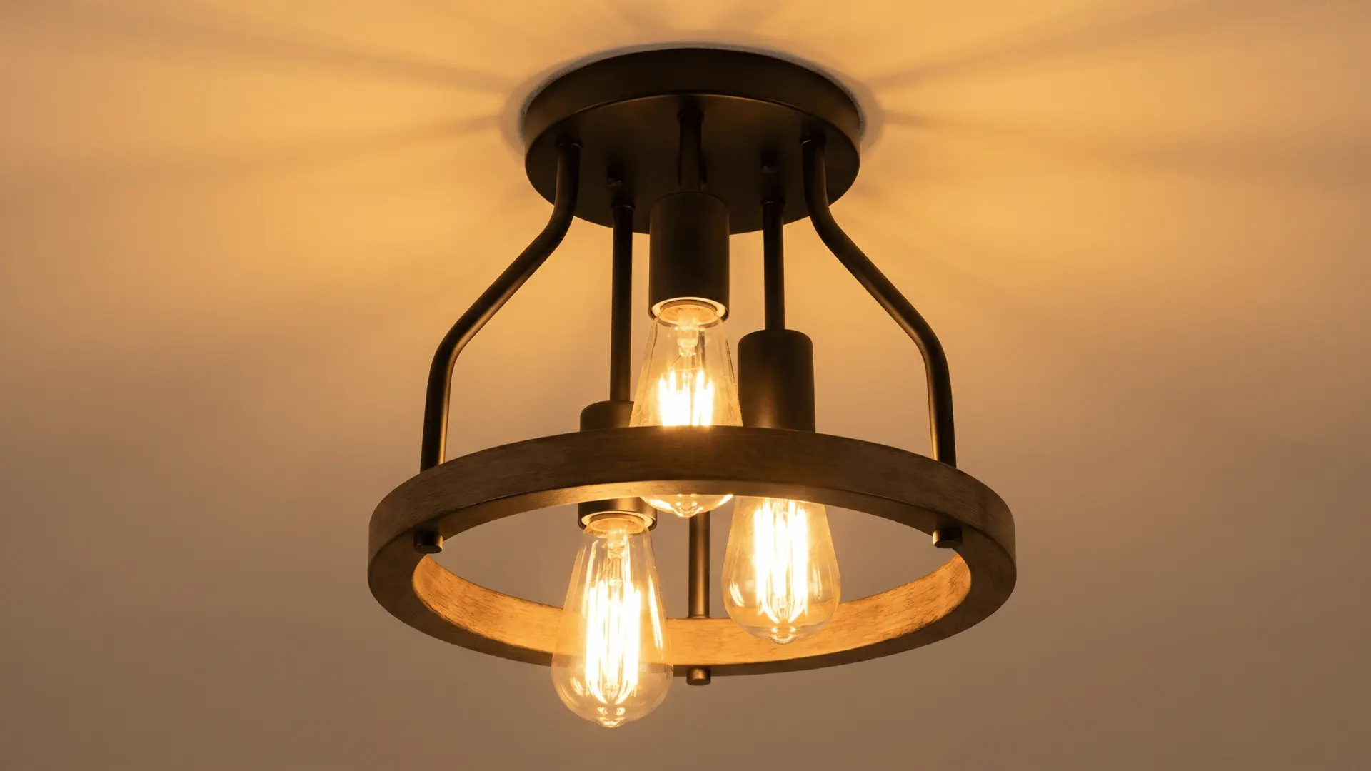 Farmhouse ceiling light with black metal frame, wooden ring detail, and warm Edison bulbs creating a soft and cozy glow