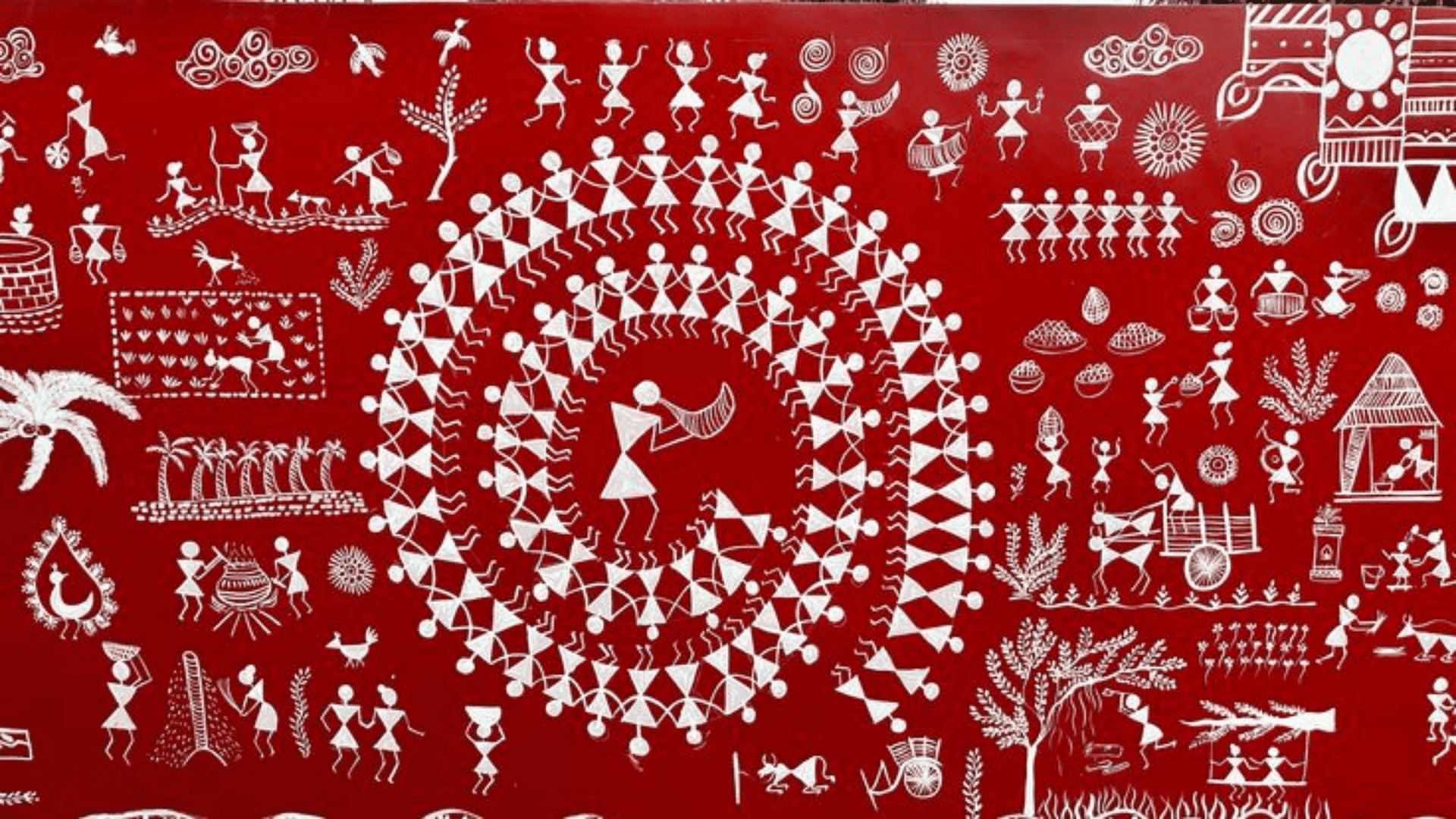 Warli folk art painting with white tribal figures forming circular patterns, depicting daily life, dancing, and nature on a red background