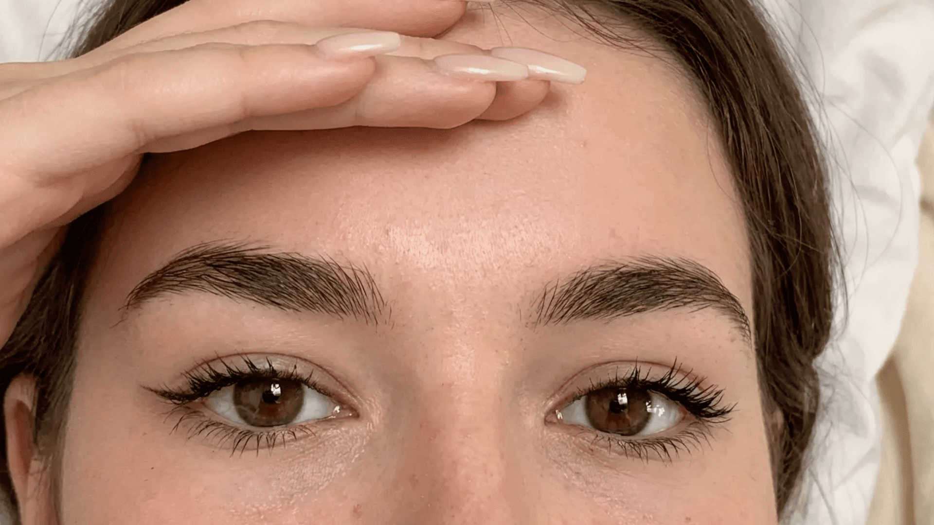 Close-up of a person with natural, straight eyebrows and minimal arch, showing a soft and balanced brow shape. (1)