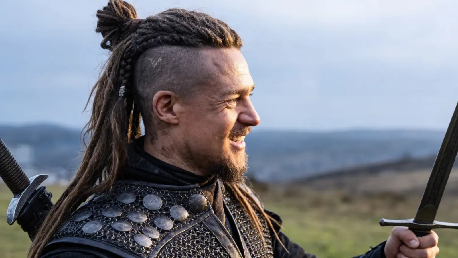 Hair with shaved sides and top tied into a knot