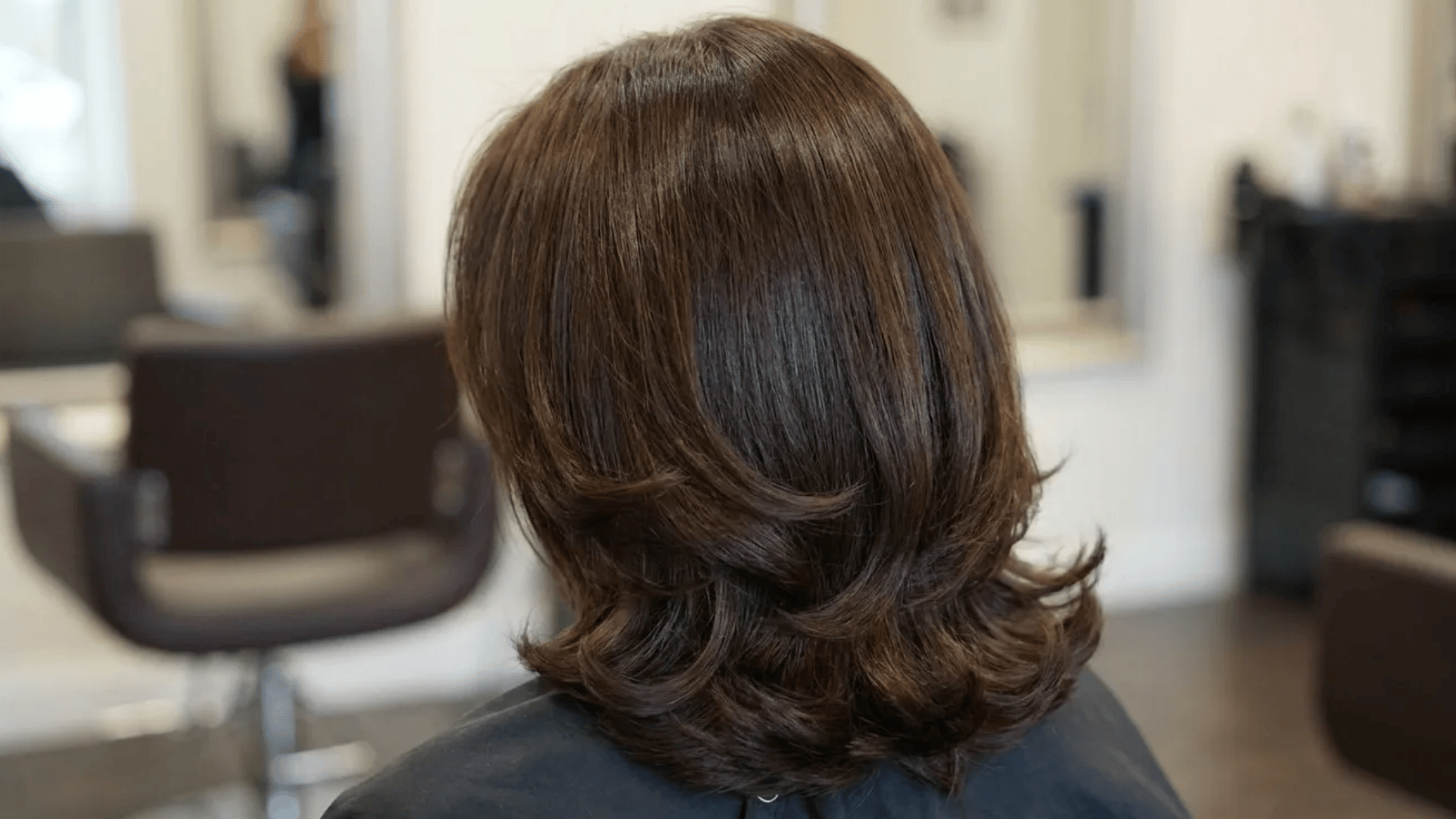 Medium-length layered blowout with smooth volume and softly flipped ends, styled for a polished salon finish