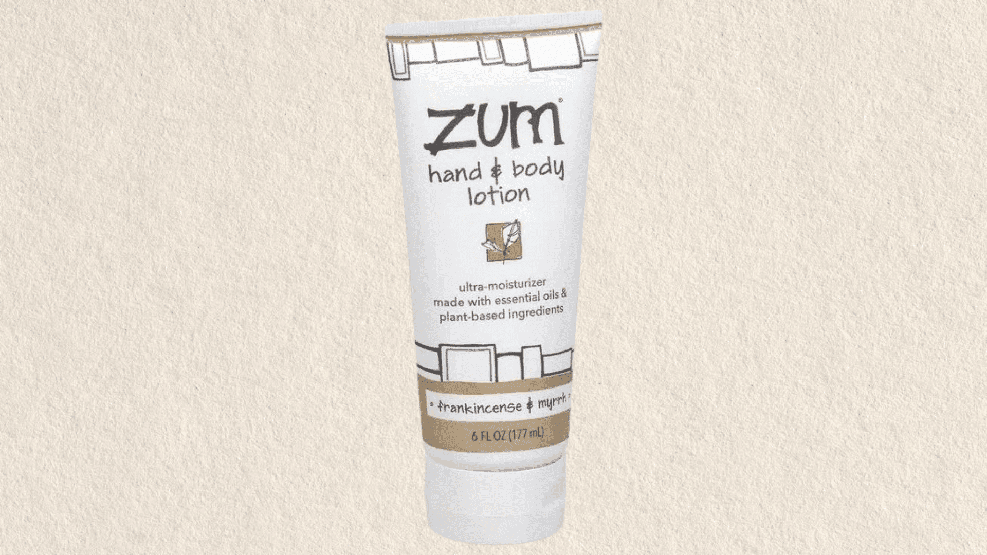 Tube of hand and body lotion labeled with frankincense and myrrh on a neutral background