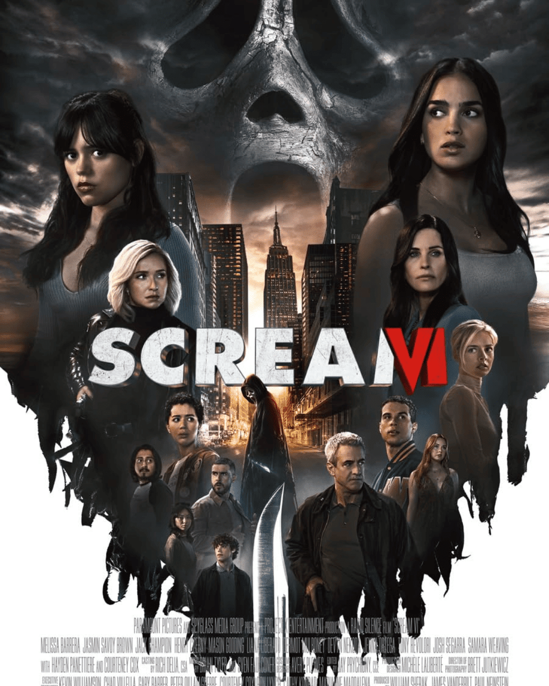 Scream VI movie poster featuring Ghostface looming over a city skyline with main cast characters in the foreground