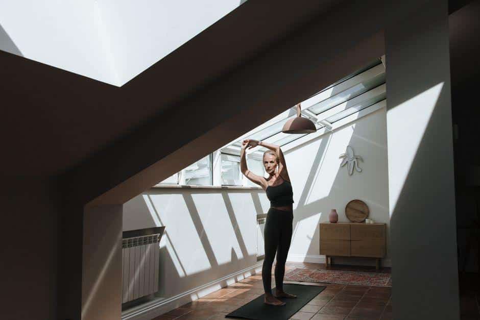 A woman doing gentle movement in a sunlit room