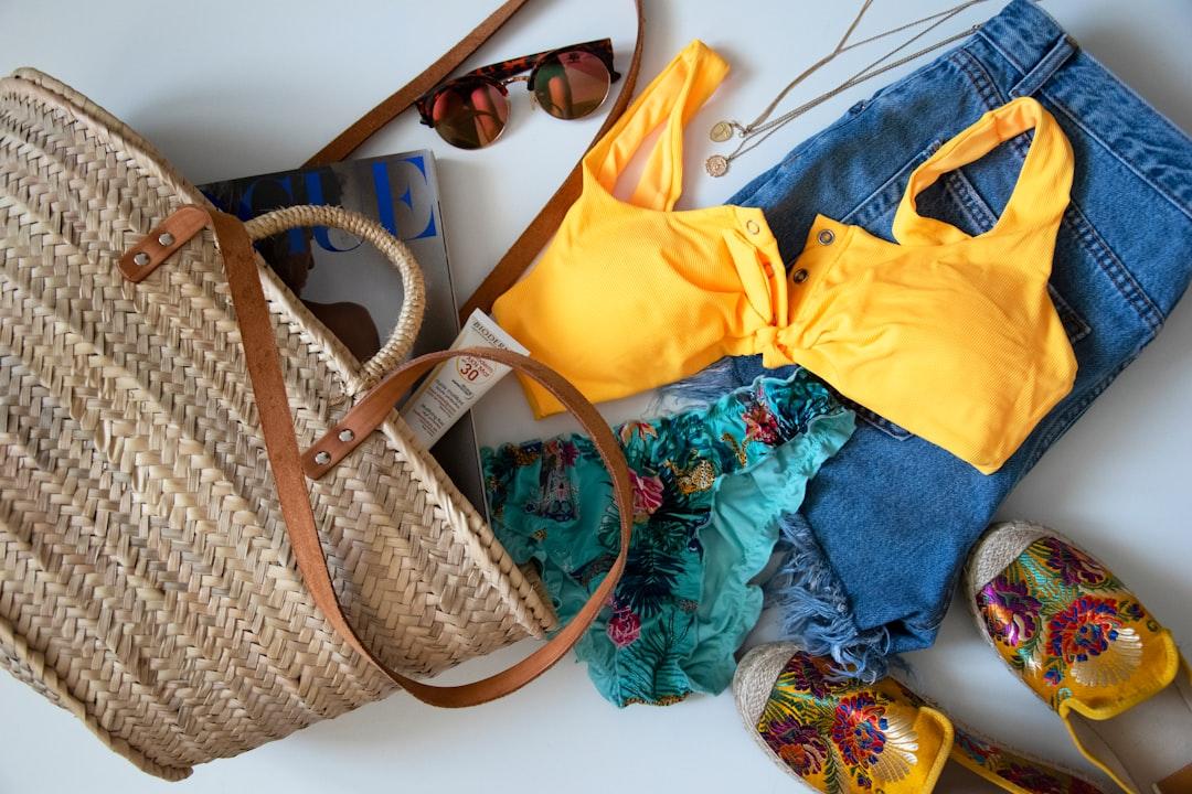 Flat lay of summer dresses, shoes, and accessories laid out for outfit planning