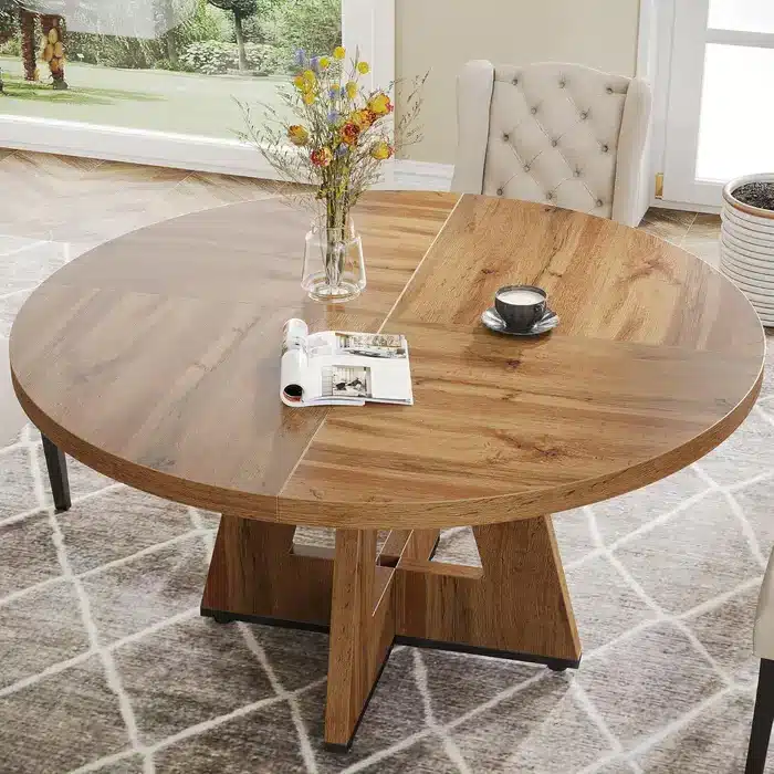 Rustic round wood table with vase of flowers and coffee cup in sunny dining room