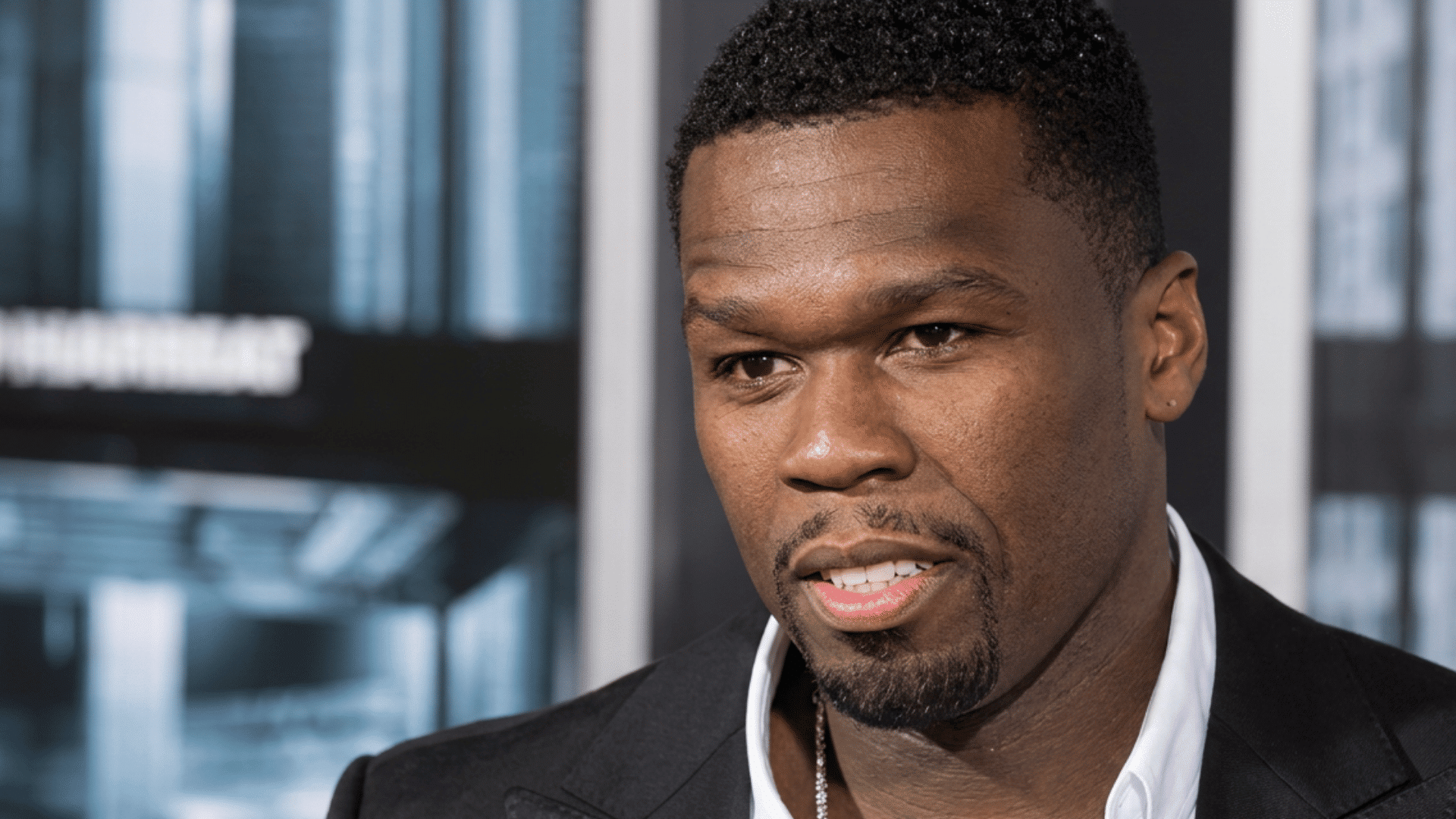 50 Cent portrait wearing a suit in a professional setting