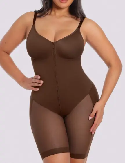 Woman wearing brown shapewear bodysuit with sheer leg sections against plain background