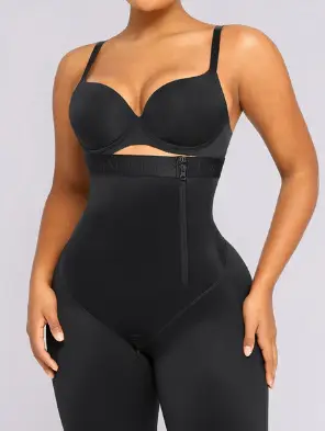 Black shapewear bodysuit with zipper detail on woman against neutral background