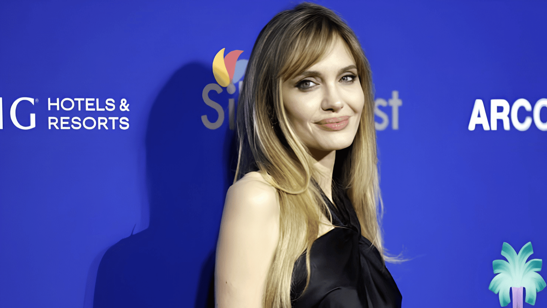 Angelena Jolie with soft side-swept bangs styling a heart-shaped face.