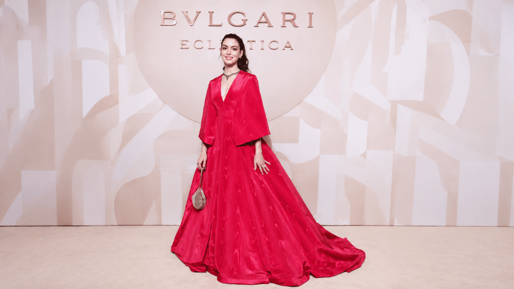 Anne Hathaway wears a bold red Valentino Haute Couture A- line gown