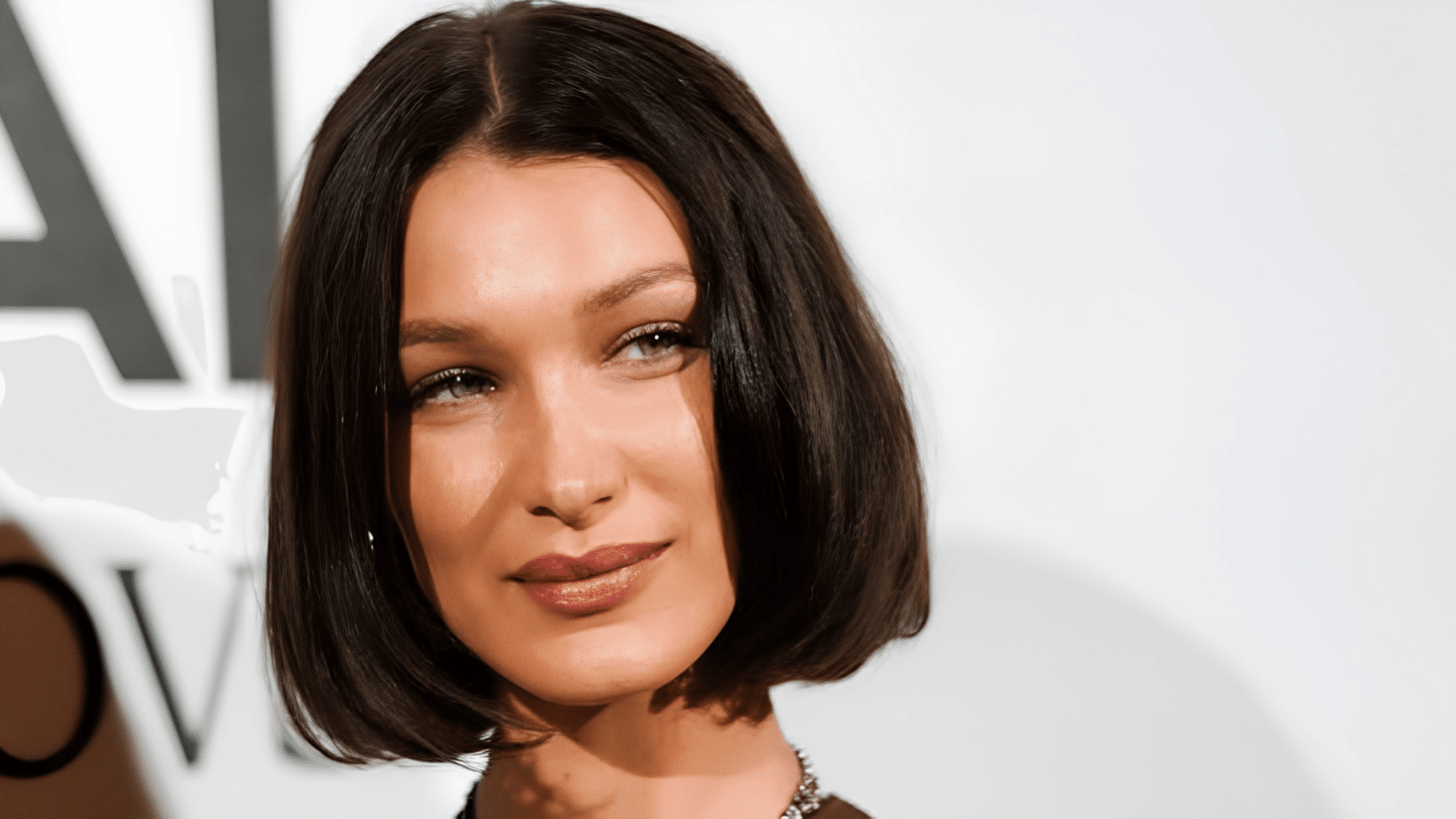 Bella Hadid with a blunt bob haircut on a heart-shaped face.