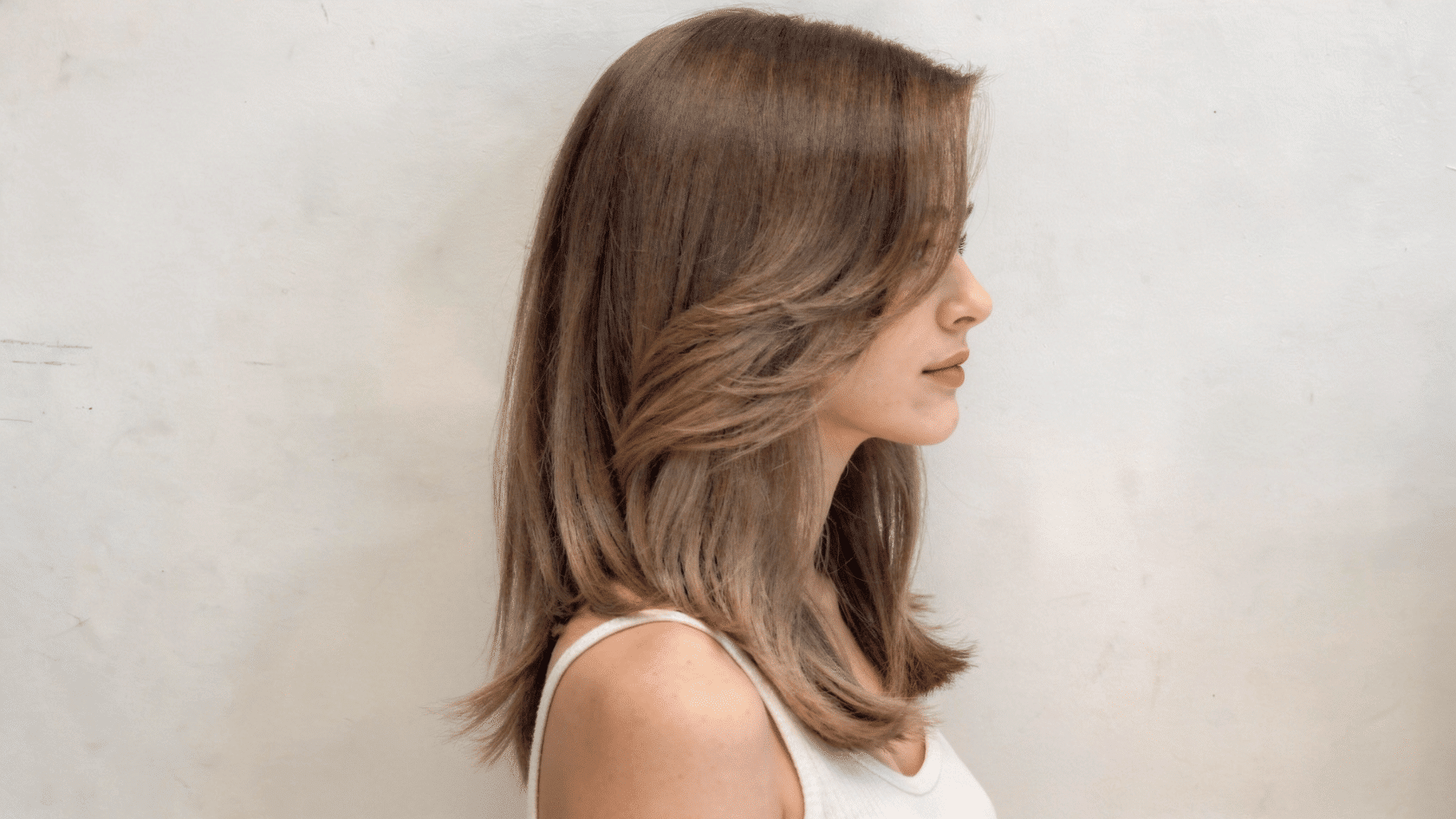 Butterfly haircut with short face-framing layers and longer layers beneath