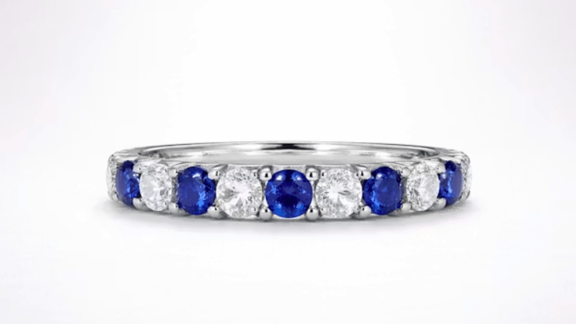 Carolyn Bessette’s platinum engagement ring with alternating blue sapphires and round-cut diamonds