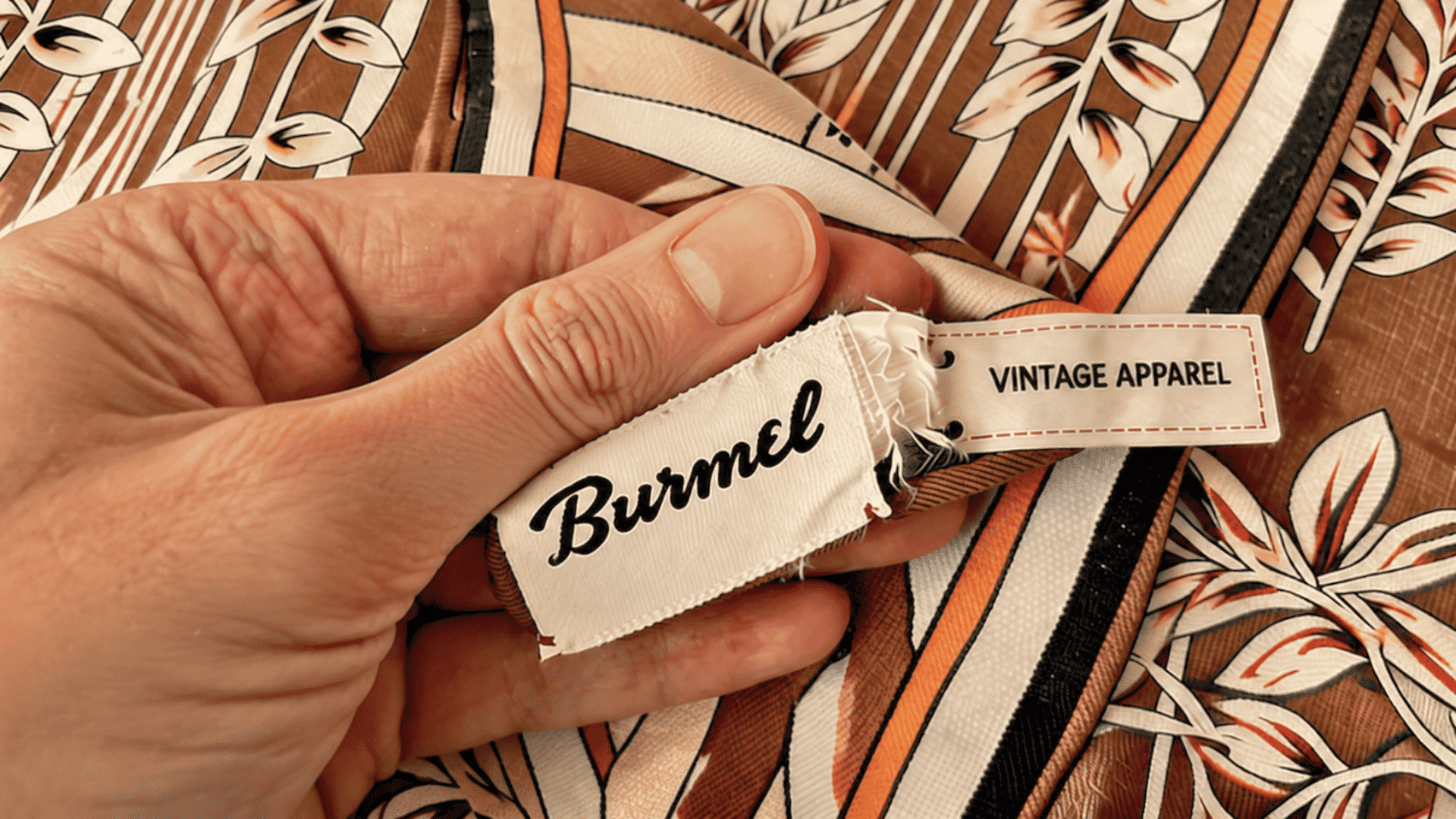Hand checking vintage clothing labels and tags for authenticity