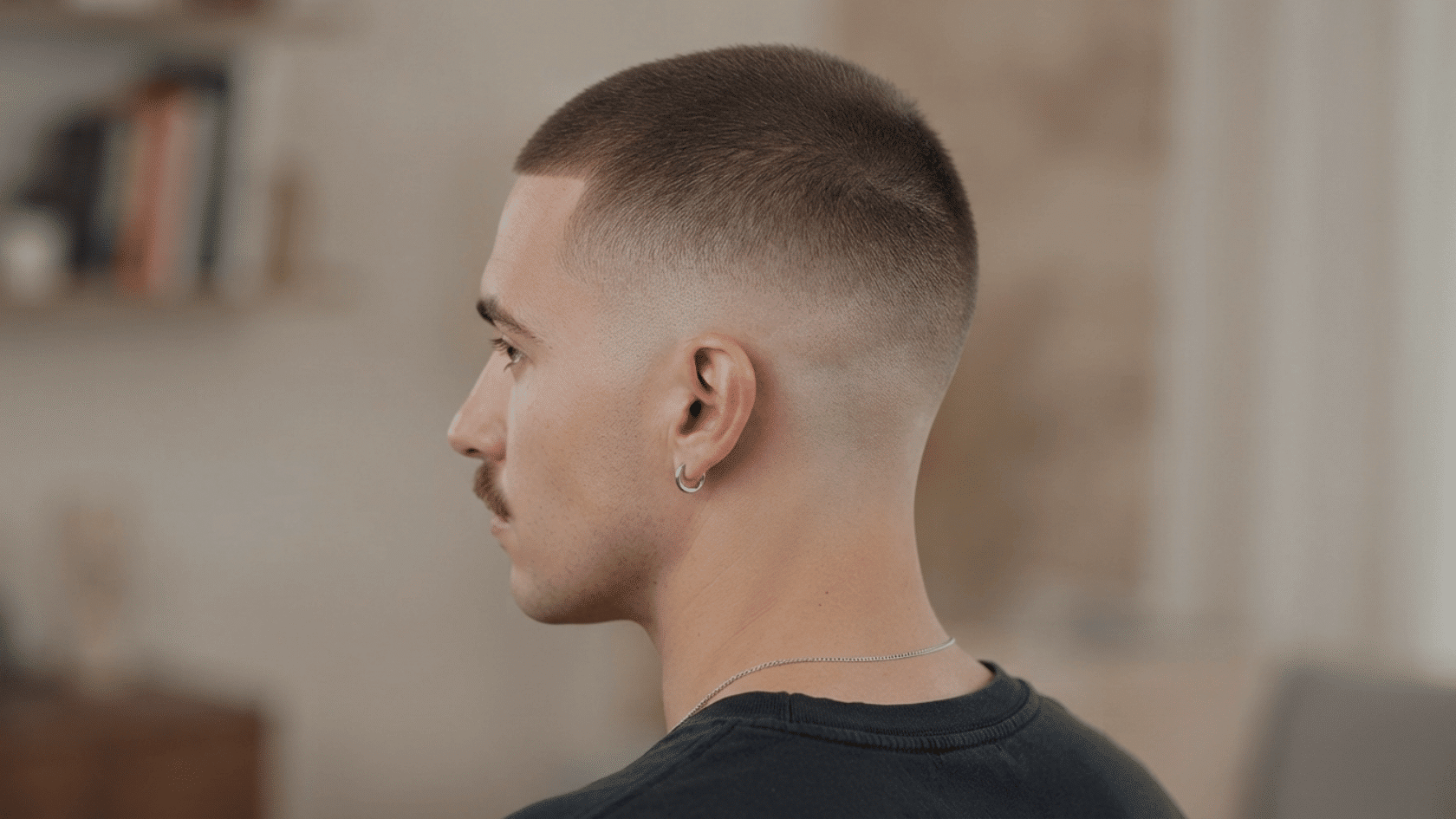 Classic short buzz cut paired with a clean mid skin fade on the sides and back