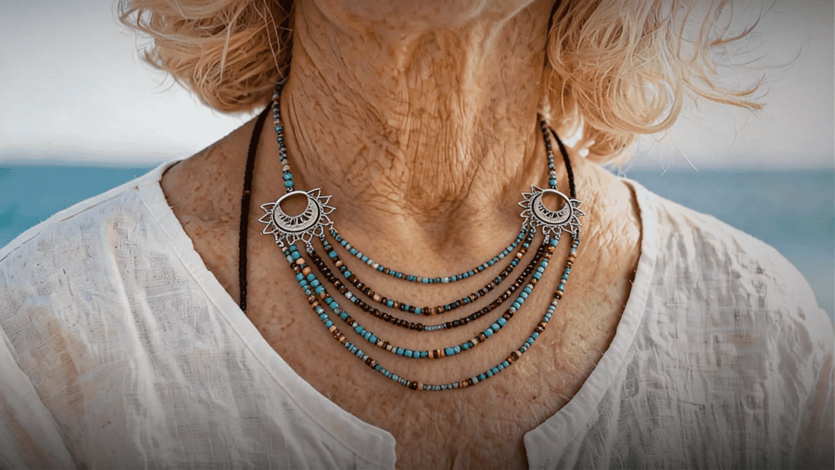 Close-up of layered boho turquoise necklace on an older woman