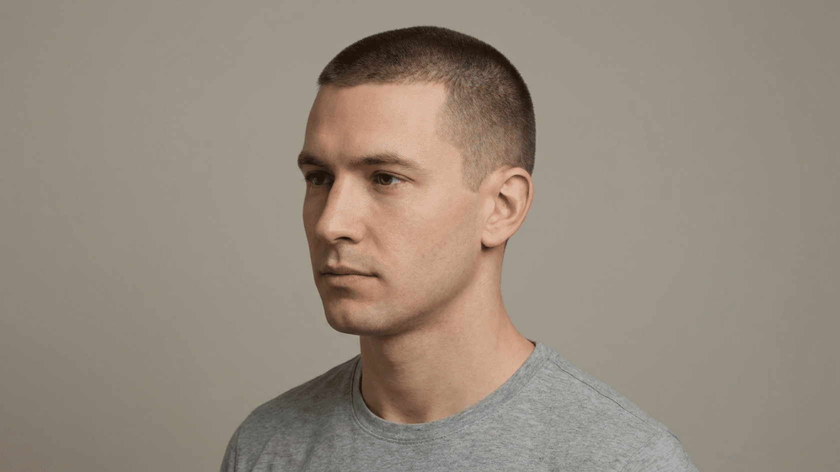 Crew cut hairstyle for men with thinning hair showing uniform short even length on top with neatly tapered sides and back, three-quarter view.