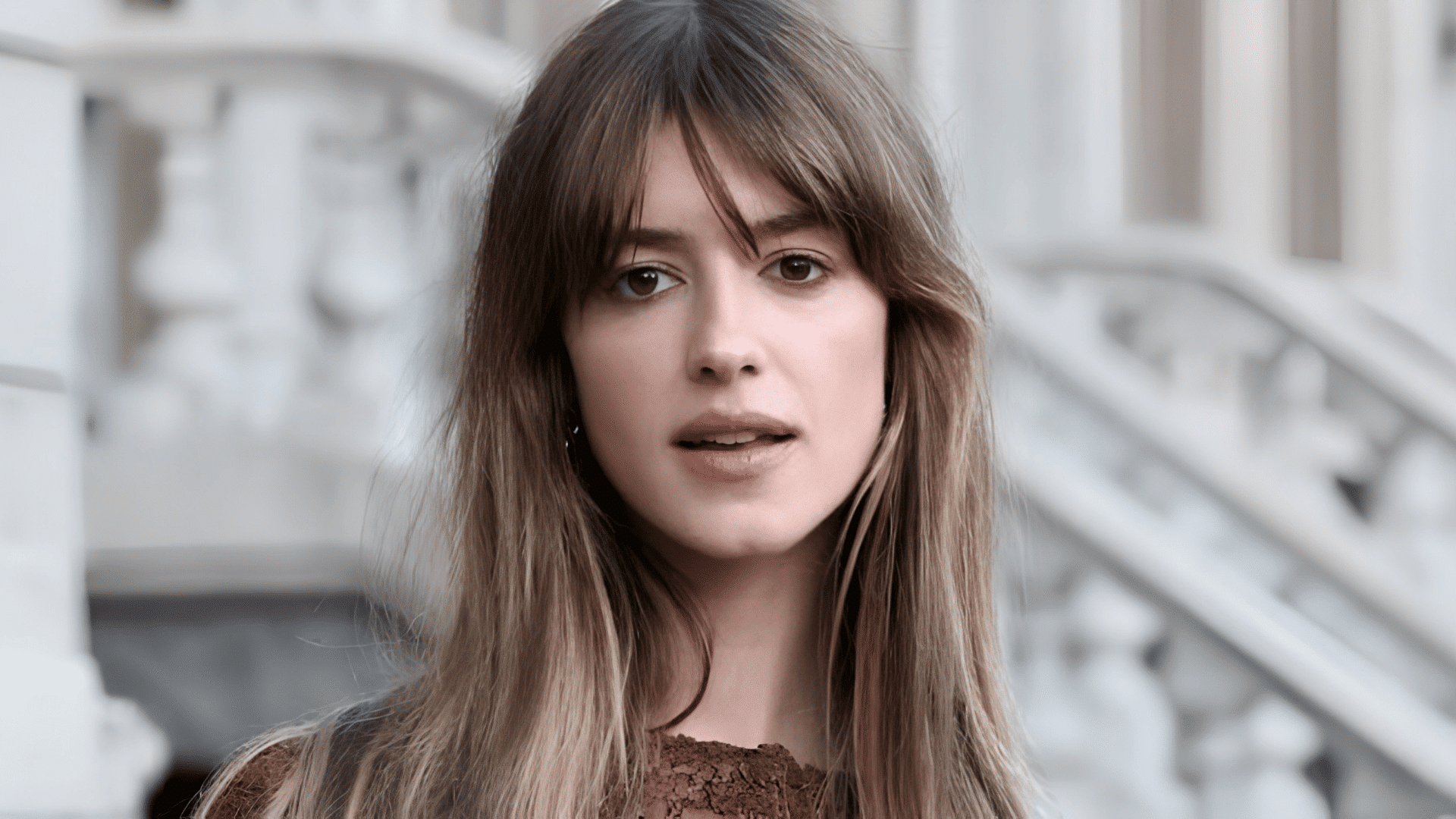 Daisy Edgar-Jones with curtain bangs framing her heart-shaped face.