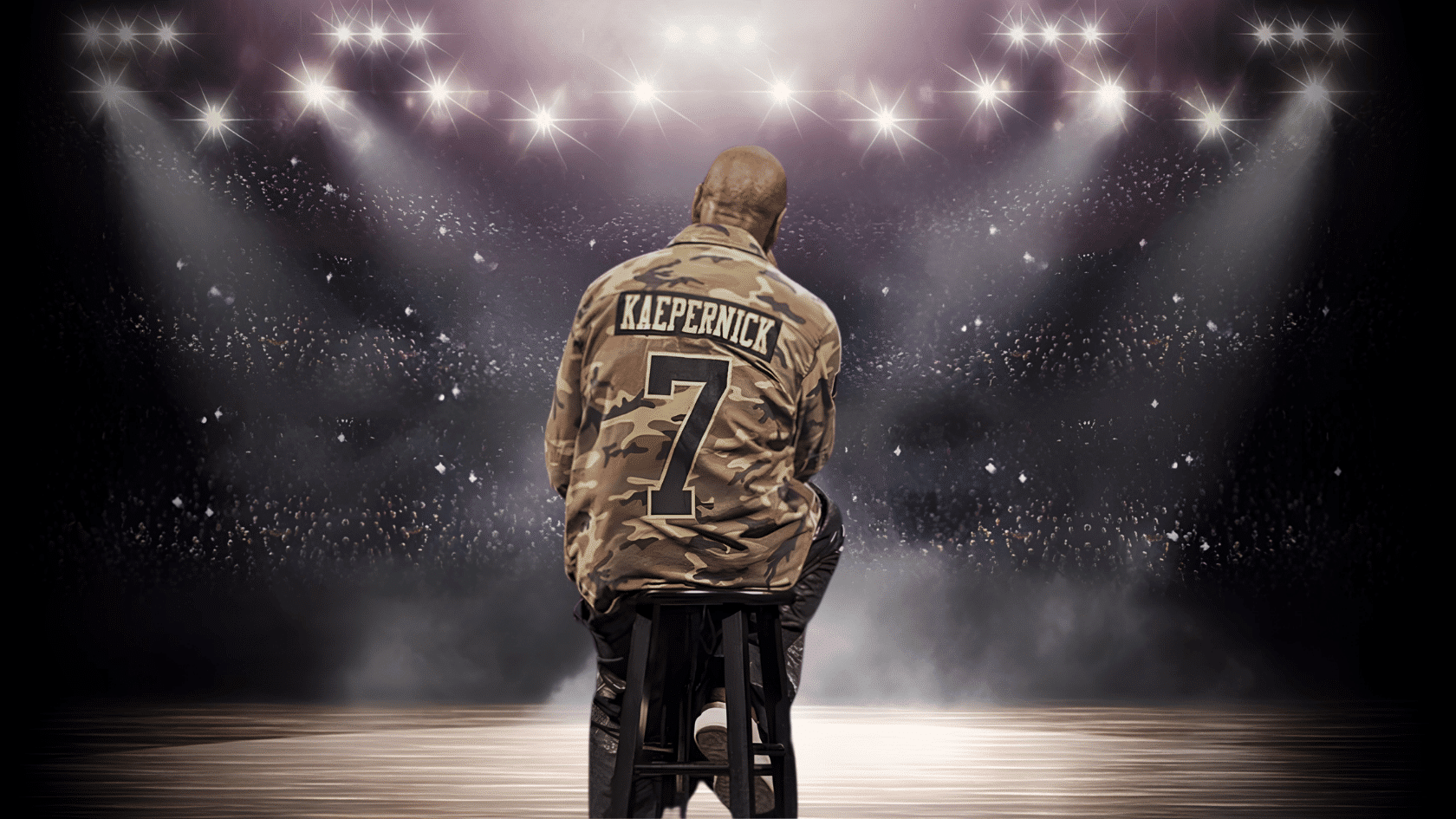 Dave Chappelle wearing a Kaepernick number 7 jersey sitting on a stool under stadium lights in a dramatic arena setting.