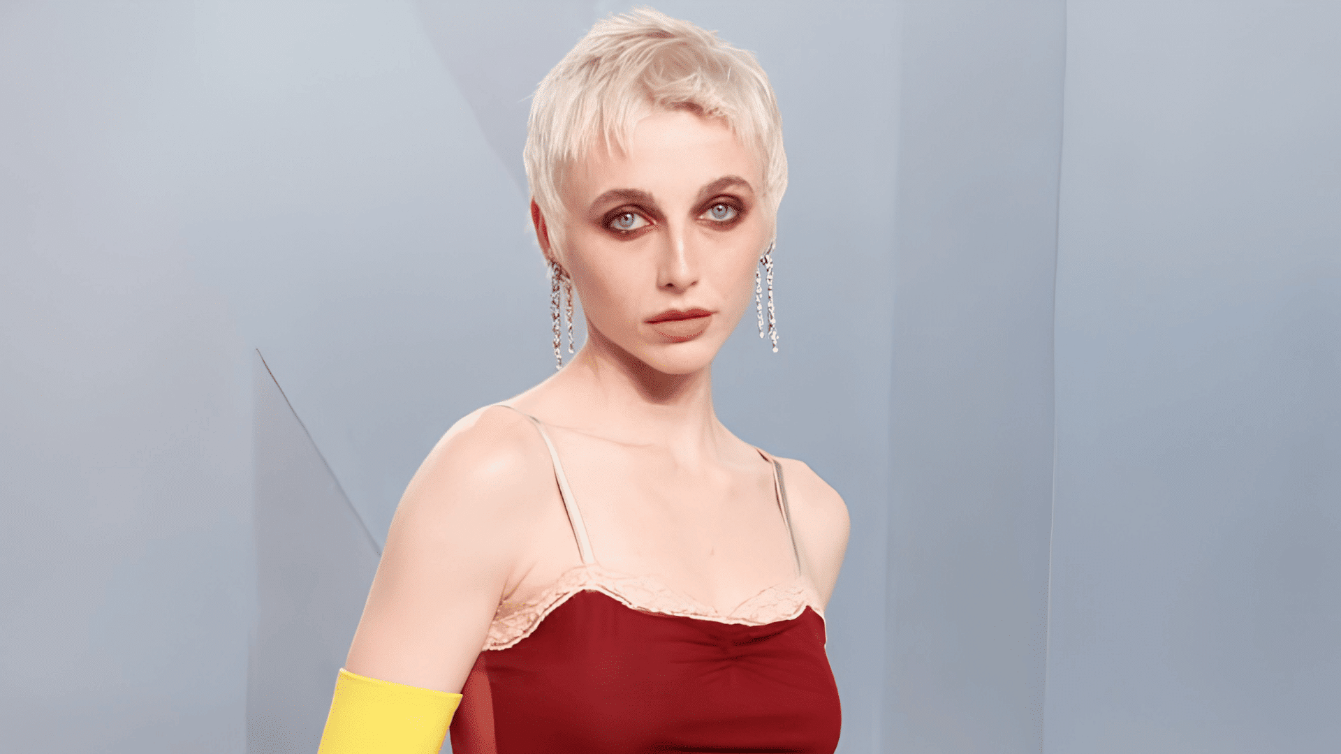 Emma Chamberlain with a piecey pixie haircut on a heart-shaped face.