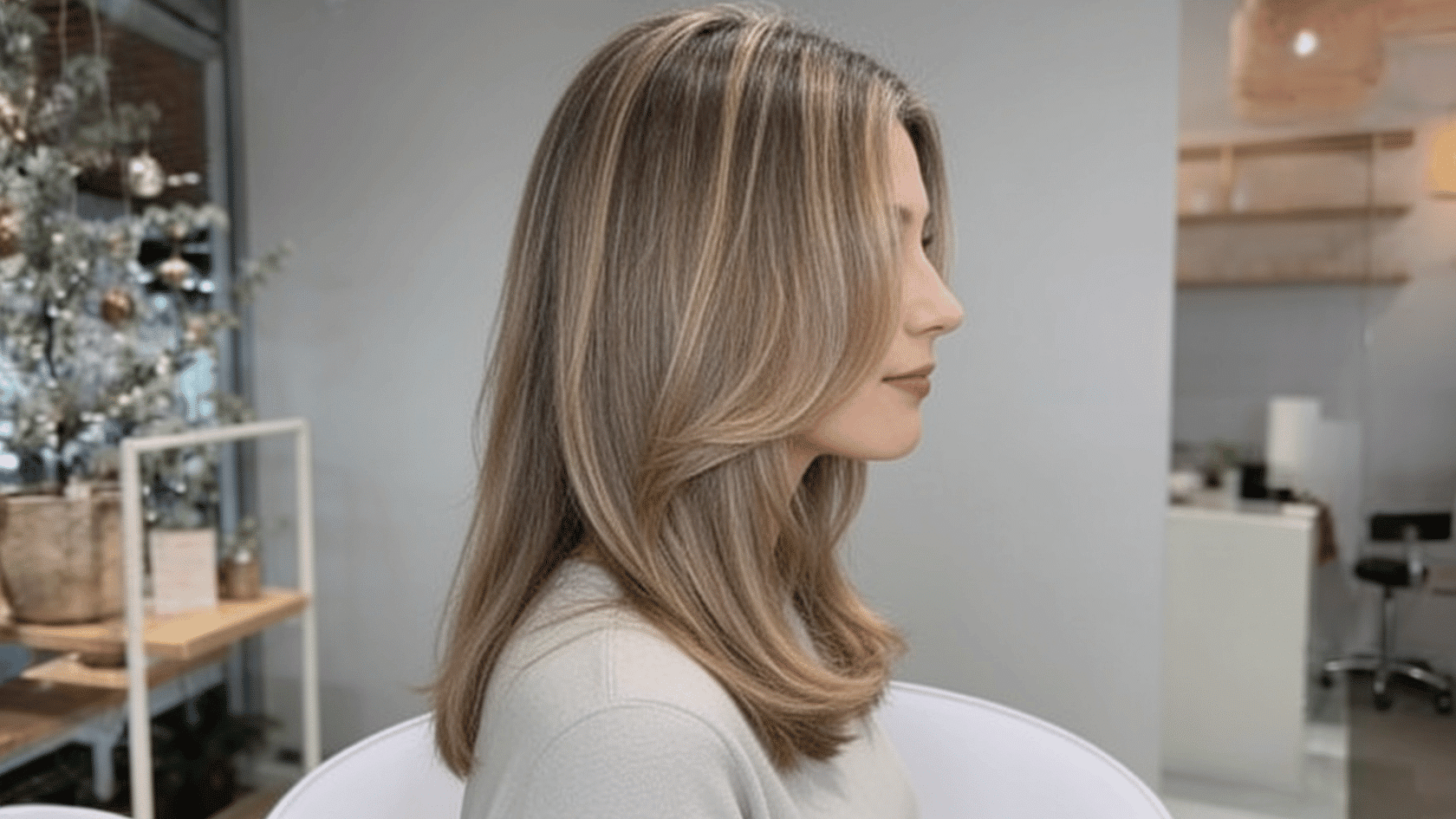 Medium-length haircut with face-framing layers around the cheekbones and jawline