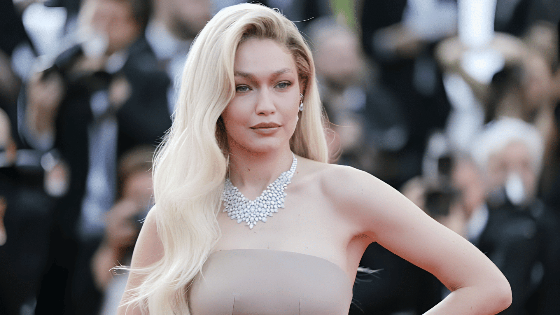 Gigi Hadid with a deep side part styling a heart-shaped face.