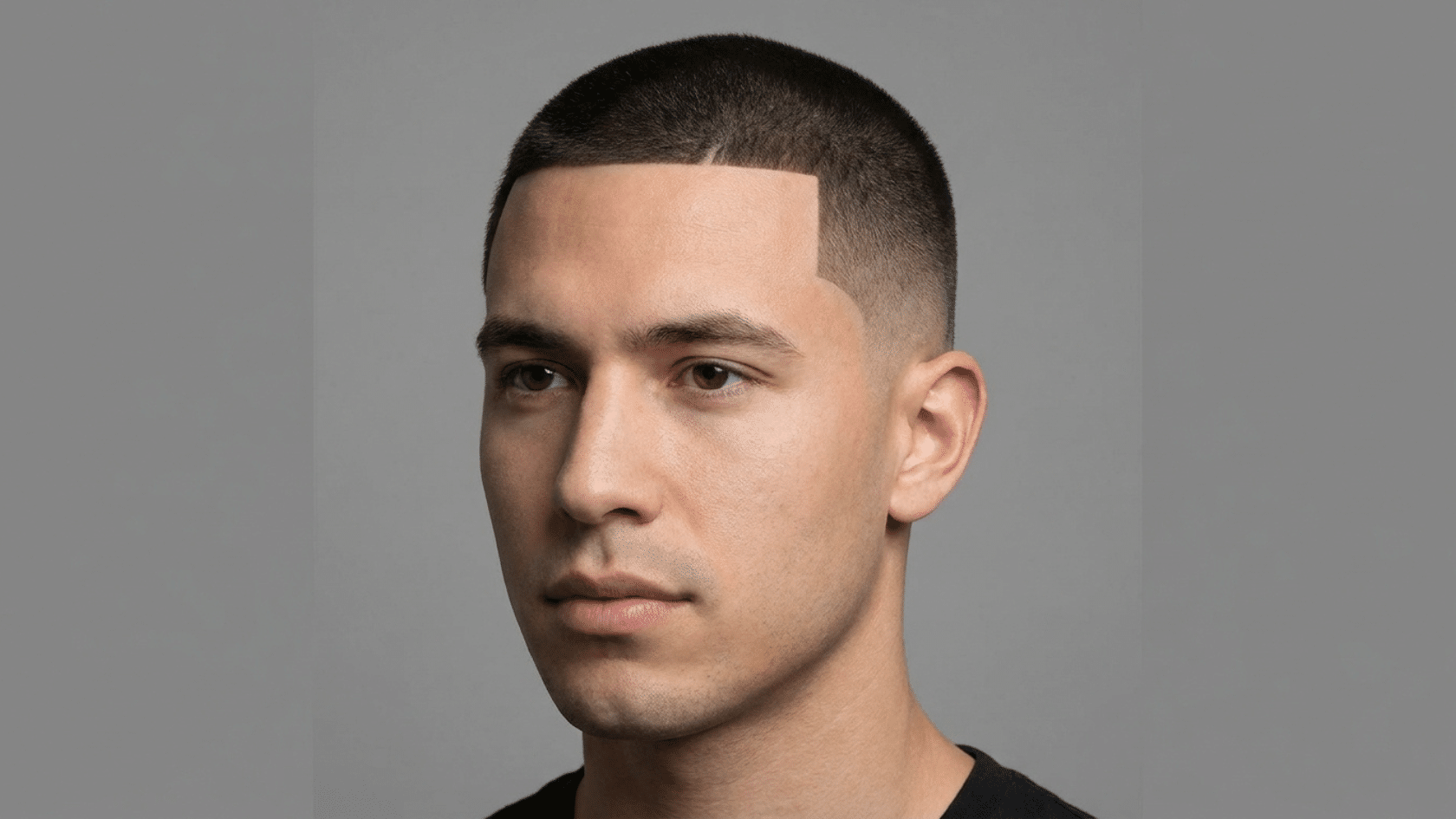 Line up hairstyle for men with thinning hair showing precisely defined straight hairline edge with neatly faded sides, front view.