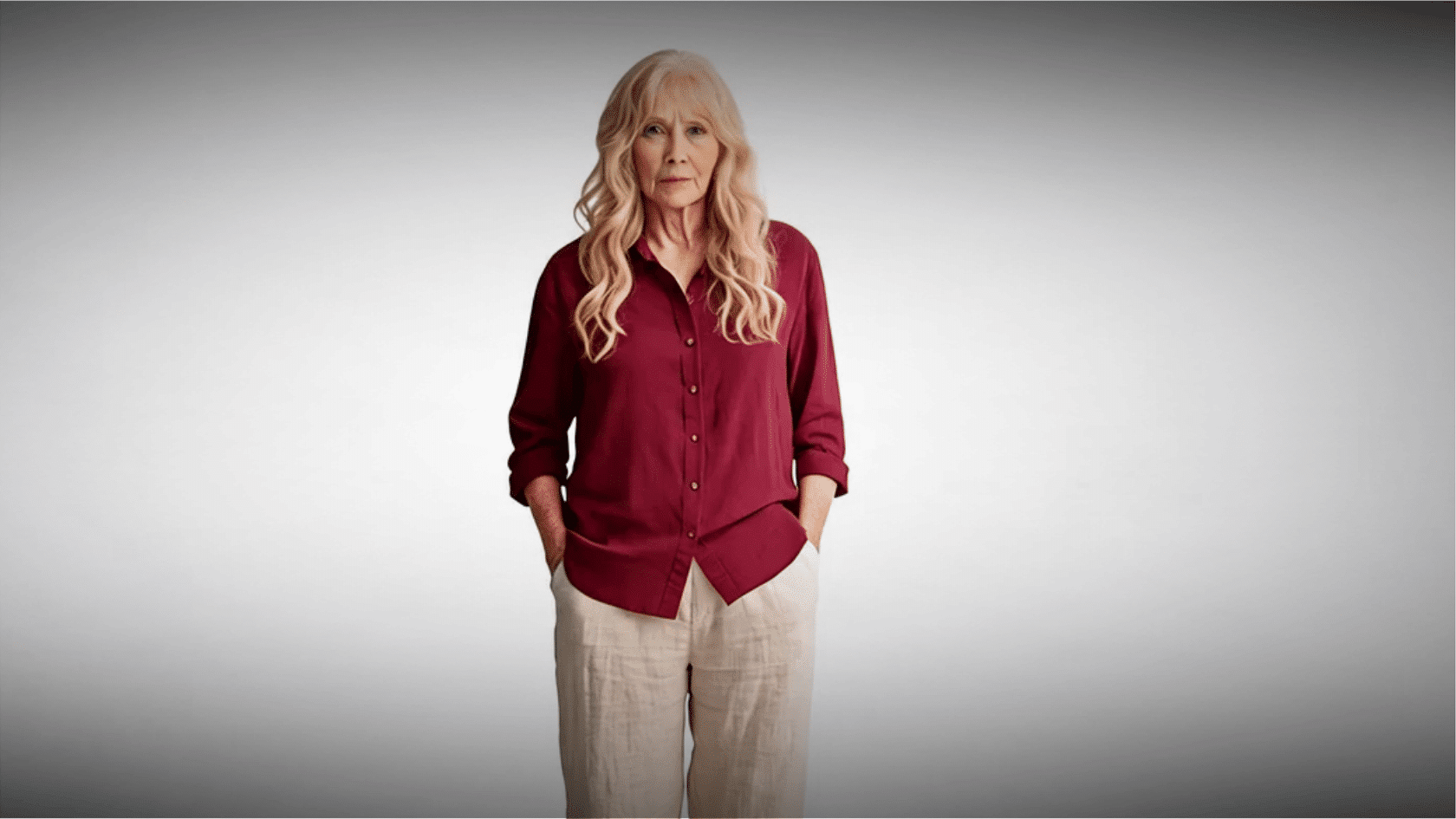 Older woman wearing a burgundy boho blouse with beige pants