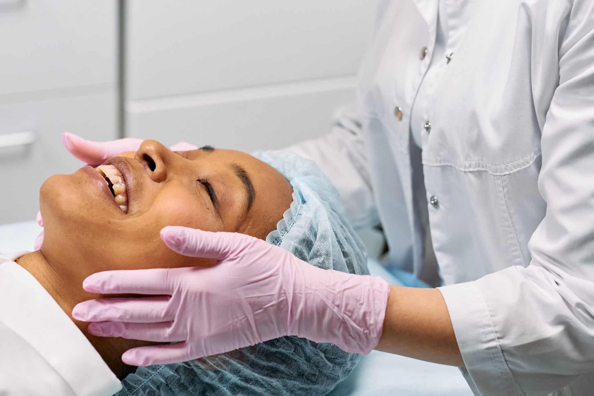 A doctor giving skin treatment to a lady