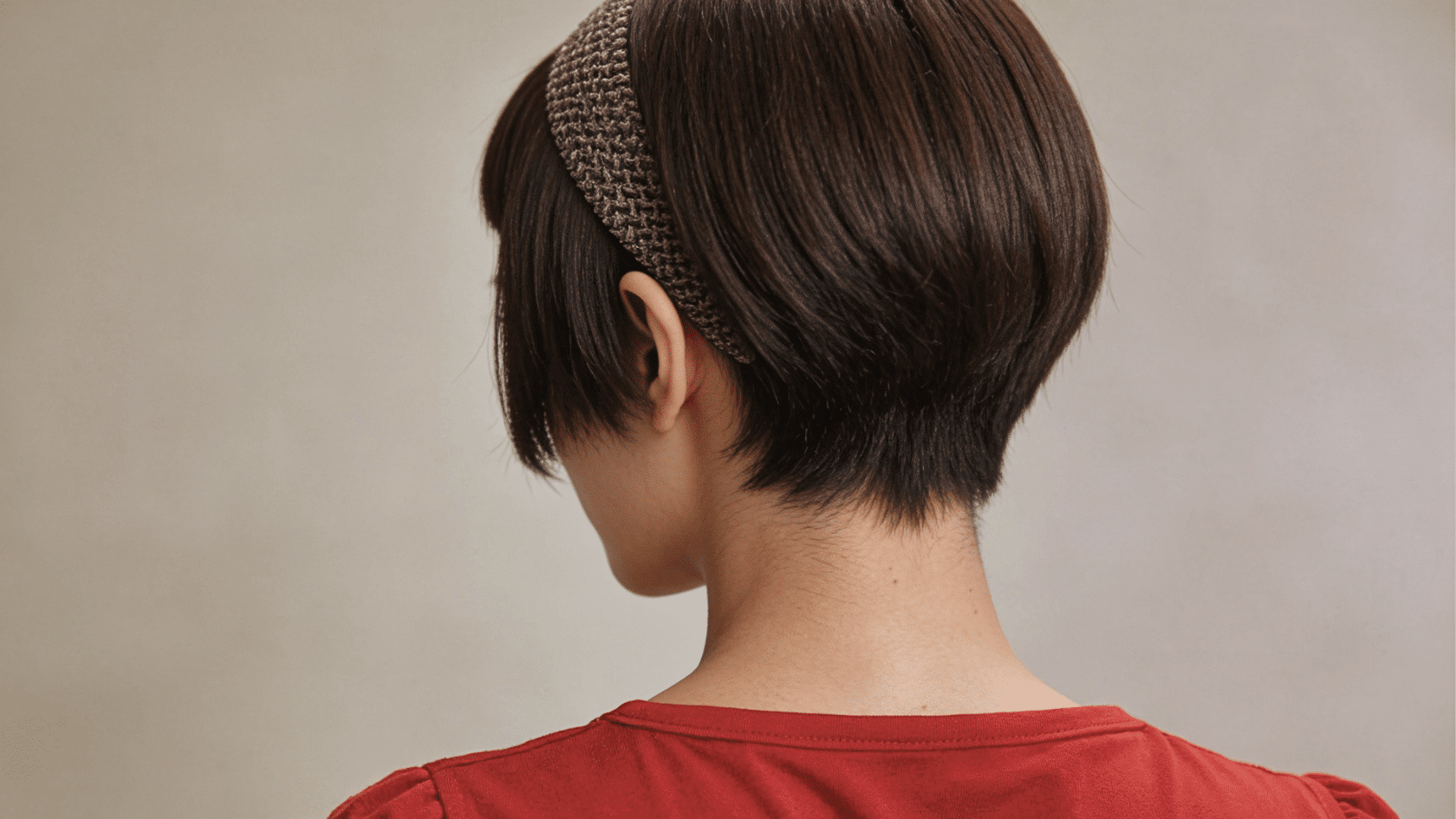 Short pixie haircut with a side-swept fringe and a flat, textured crown