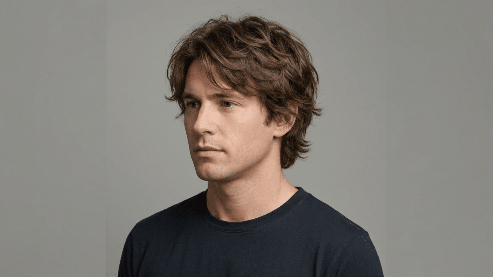 Scissor cut hairstyle for men with thinning hair showing soft natural layers distributed evenly across the head with no clipper lines, three-quarter view.
