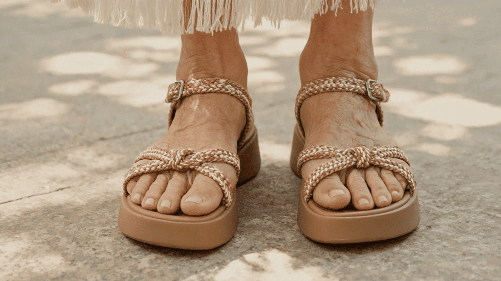 Supportive boho sandals with braided straps worn by an older woman