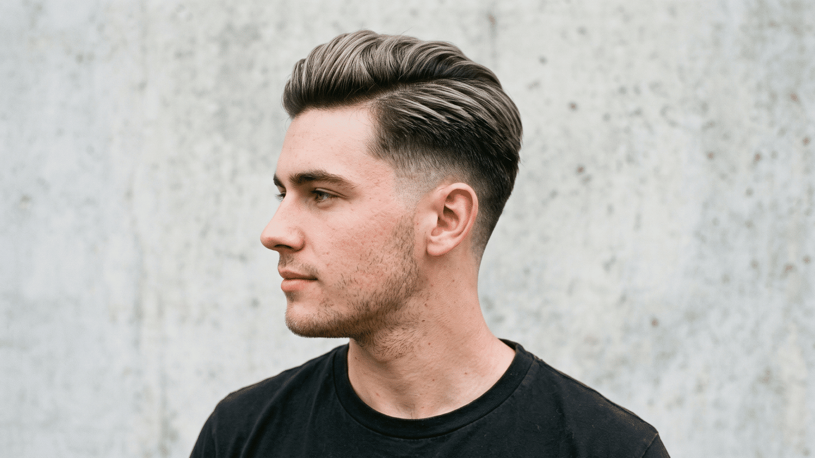 Tapered side part haircut with short faded sides and neatly styled side-parted hair on top.