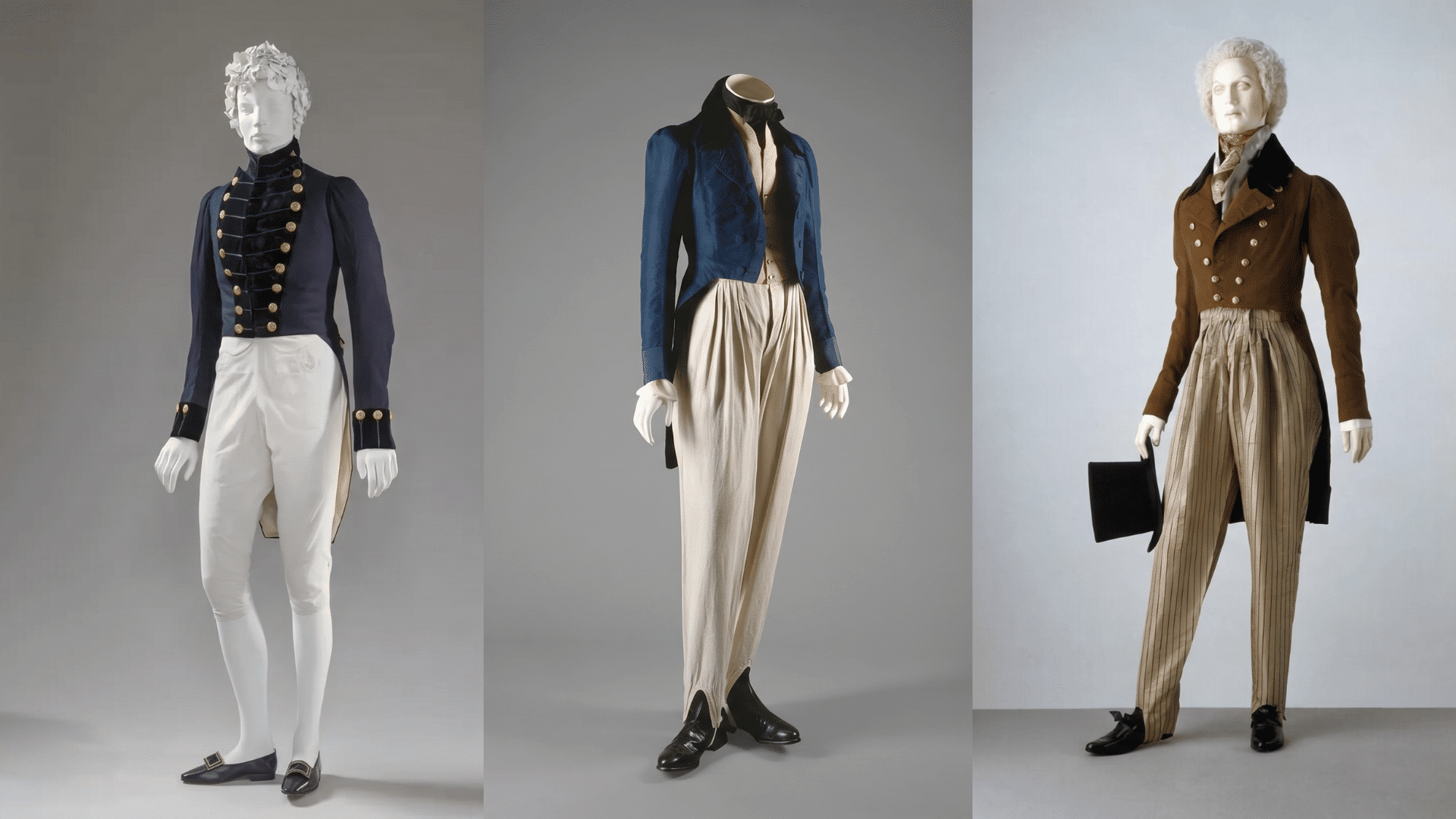 Three Regency era men's tailcoat ensembles on mannequins in navy, blue, and brown with fitted trousers and waistcoats.