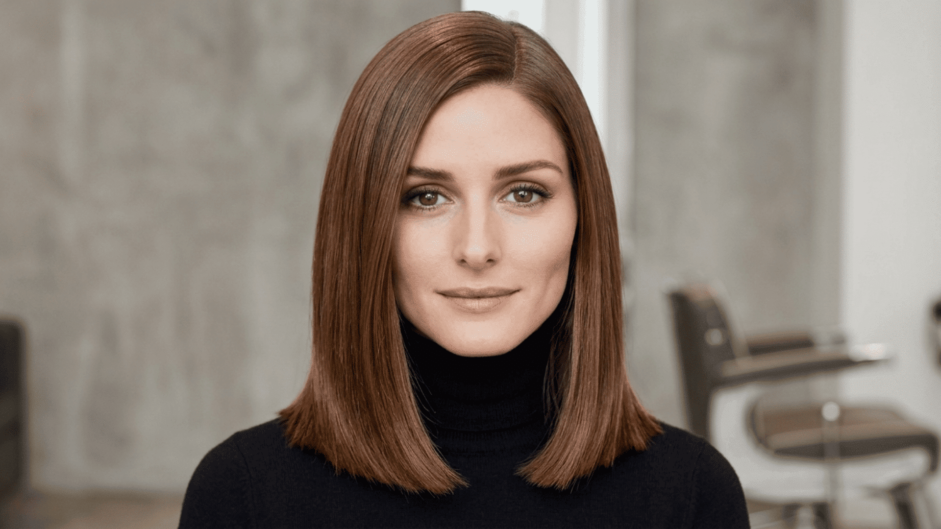 Woman with a sleek classic lob haircut ending at the collarbone with straight, polished styling and a side part.
