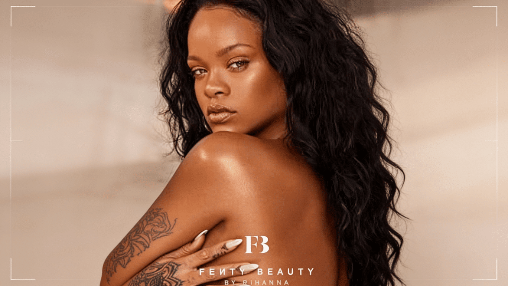 Woman with long wavy black hair looking over shoulder, Fenty Beauty branding overlay