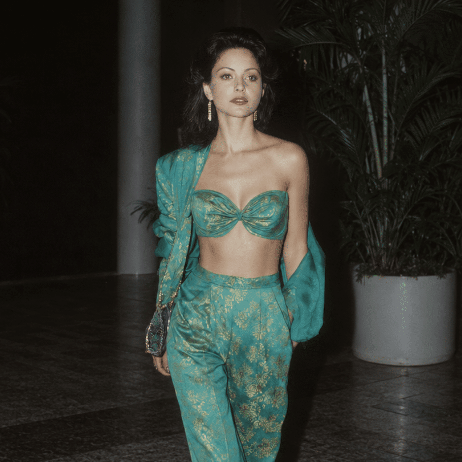 Actress and singer Apollonia Kotero in a turquoise and gold two-piece outfit