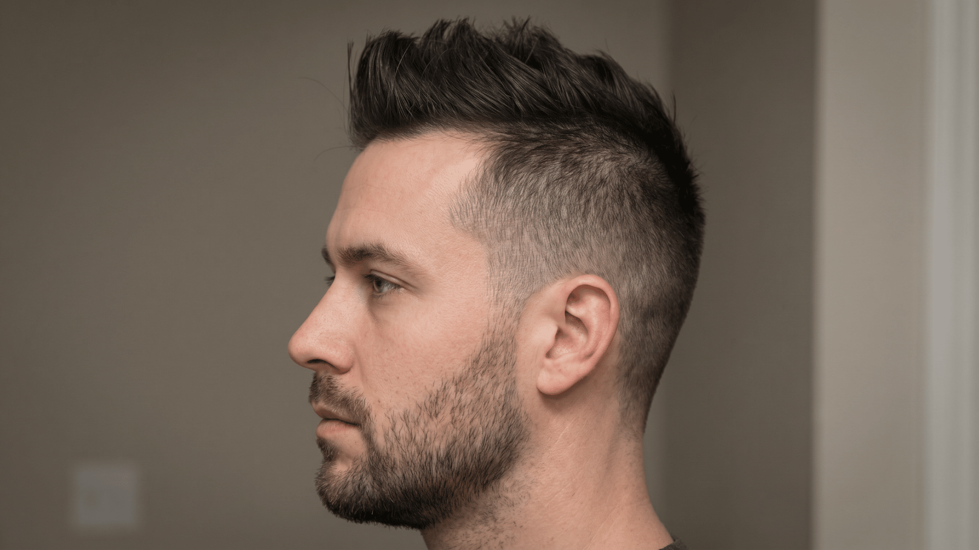 Faux hawk with raised center hair and faded sides, showing one of the types of mohawks for men