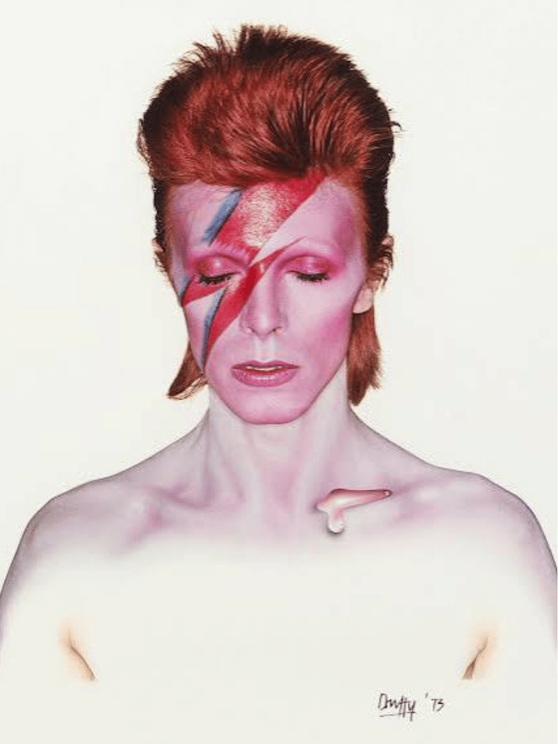 David Bowie โ Aladdin Sane album cover featuring red hair and red-blue lightning face makeup.