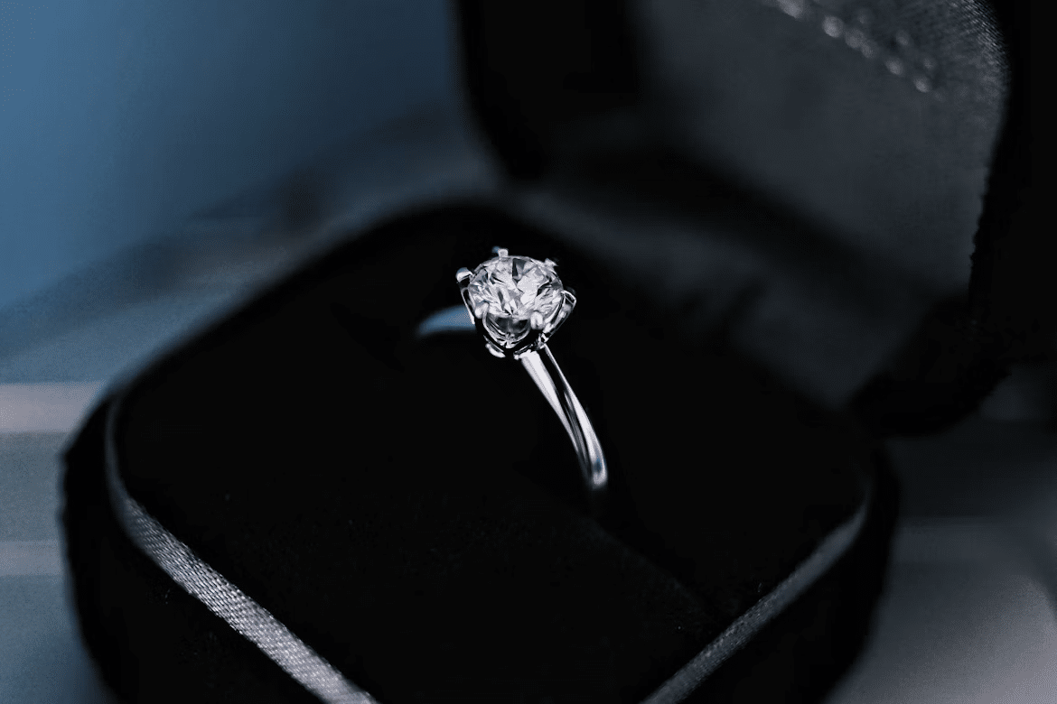 Diamond engagement ring in velvet jewelry box under soft lighting