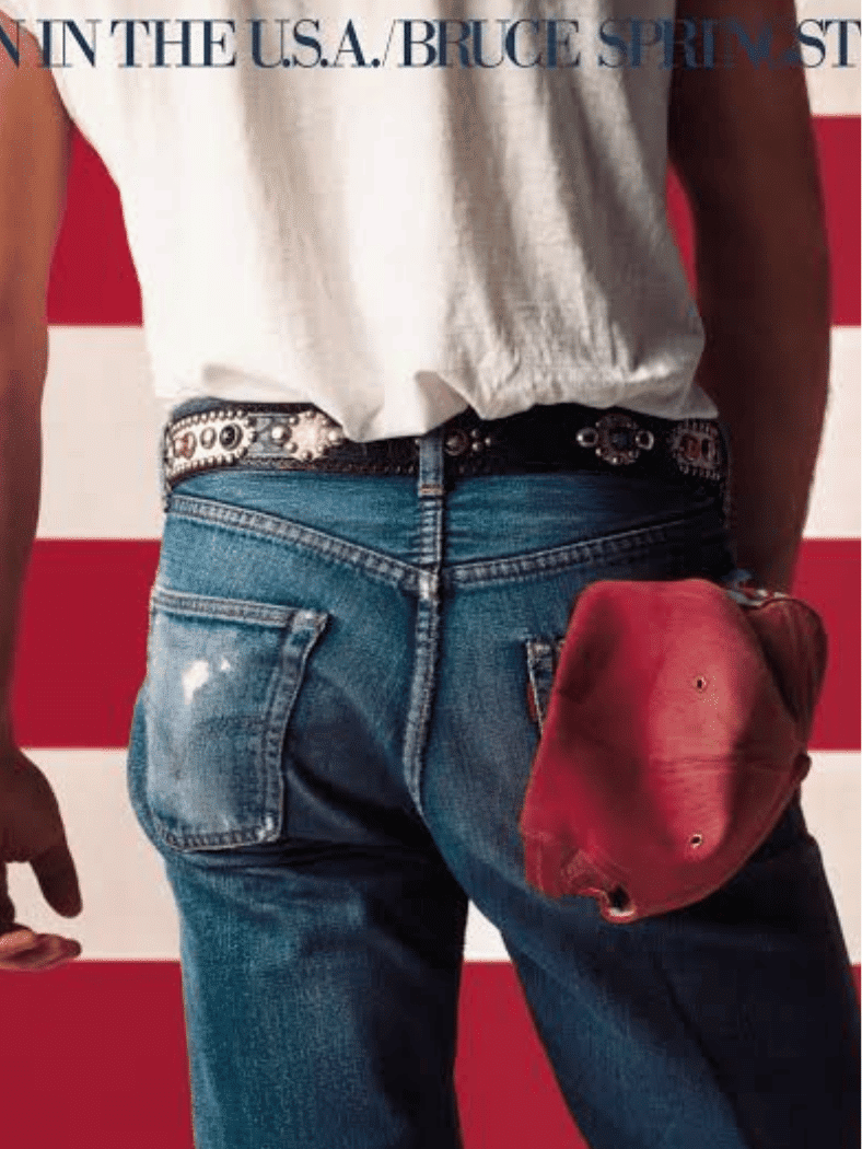 Bruce Springsteen โ Born in the U.S.A. album cover showing jeans, a red cap, and an American flag.