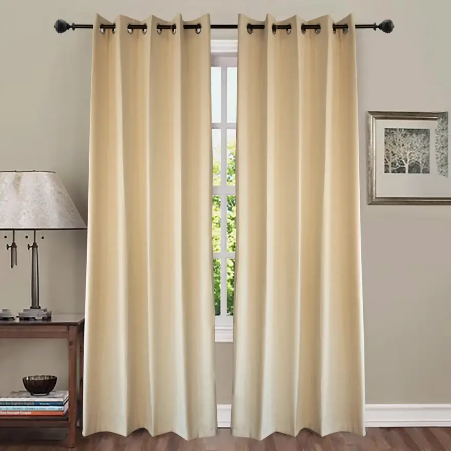 Cream curtains on window with black rod in cozy living room setting