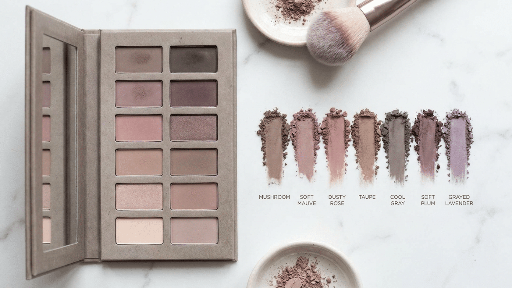 Soft summer makeup eyeshadow palette with cool mauve and gray tones arranged on marble surface