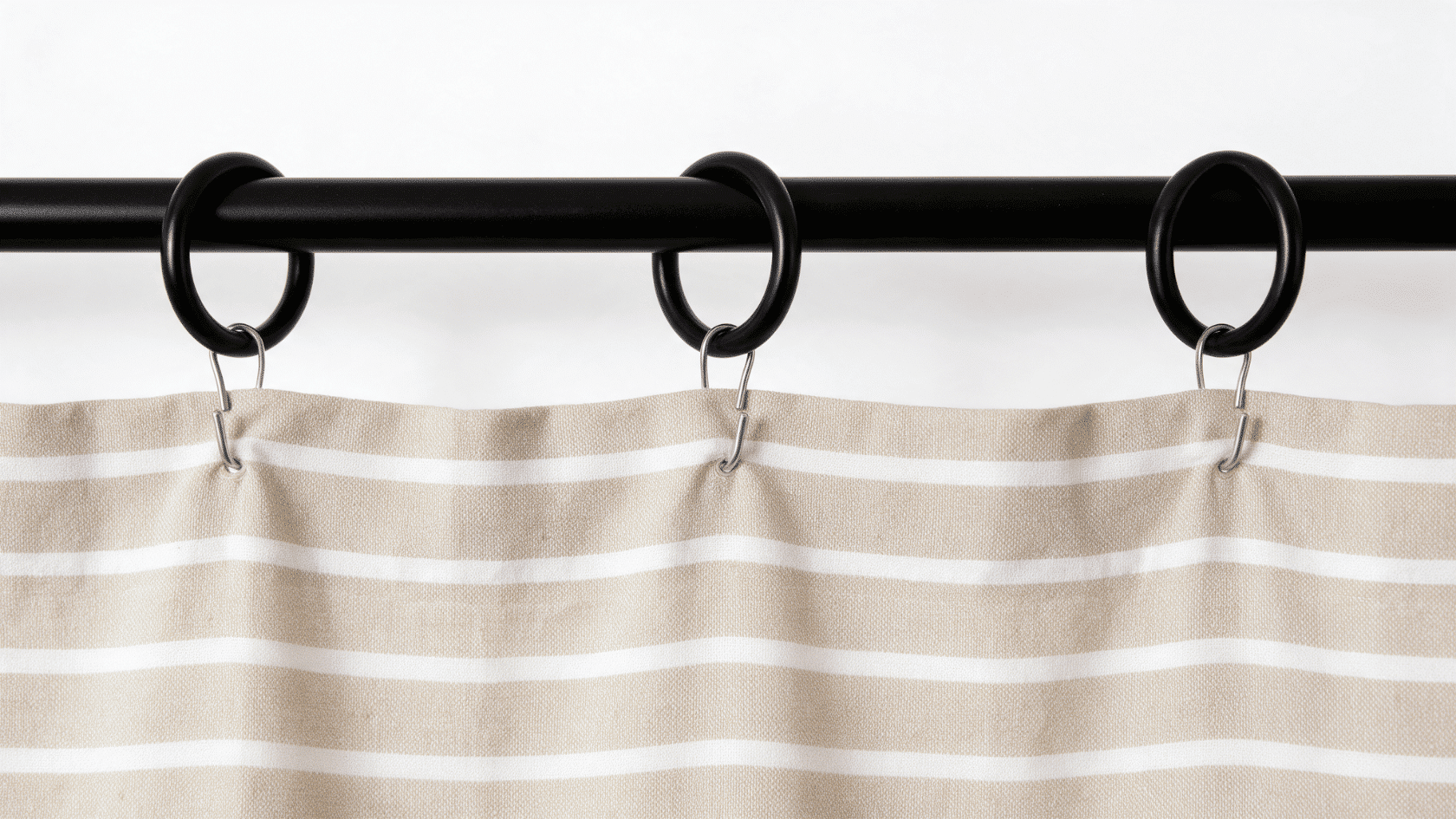 Curtains attached to a rod using curtain clips for a simple window hanging method.