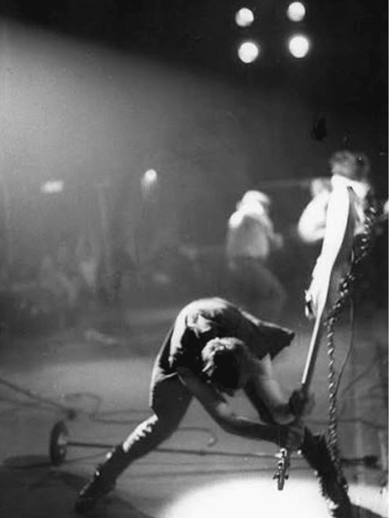London Calling by The Clash album cover showing a bassist smashing his guitar onstage.