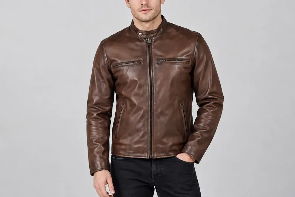 Brown leather jacket worn by a person standing against a neutral background